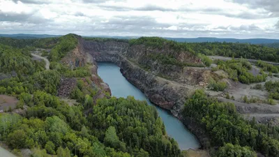 Aerial view of a green landscape and iron mine in Wawa, Ontario.