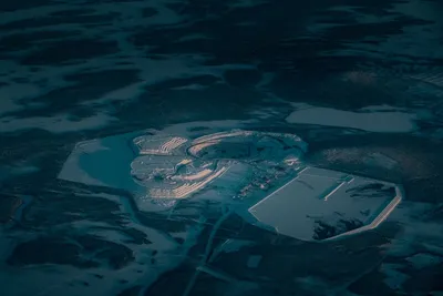 Drone view of open pit with mining located on frozen terrain in evening time on cold winter time in nature